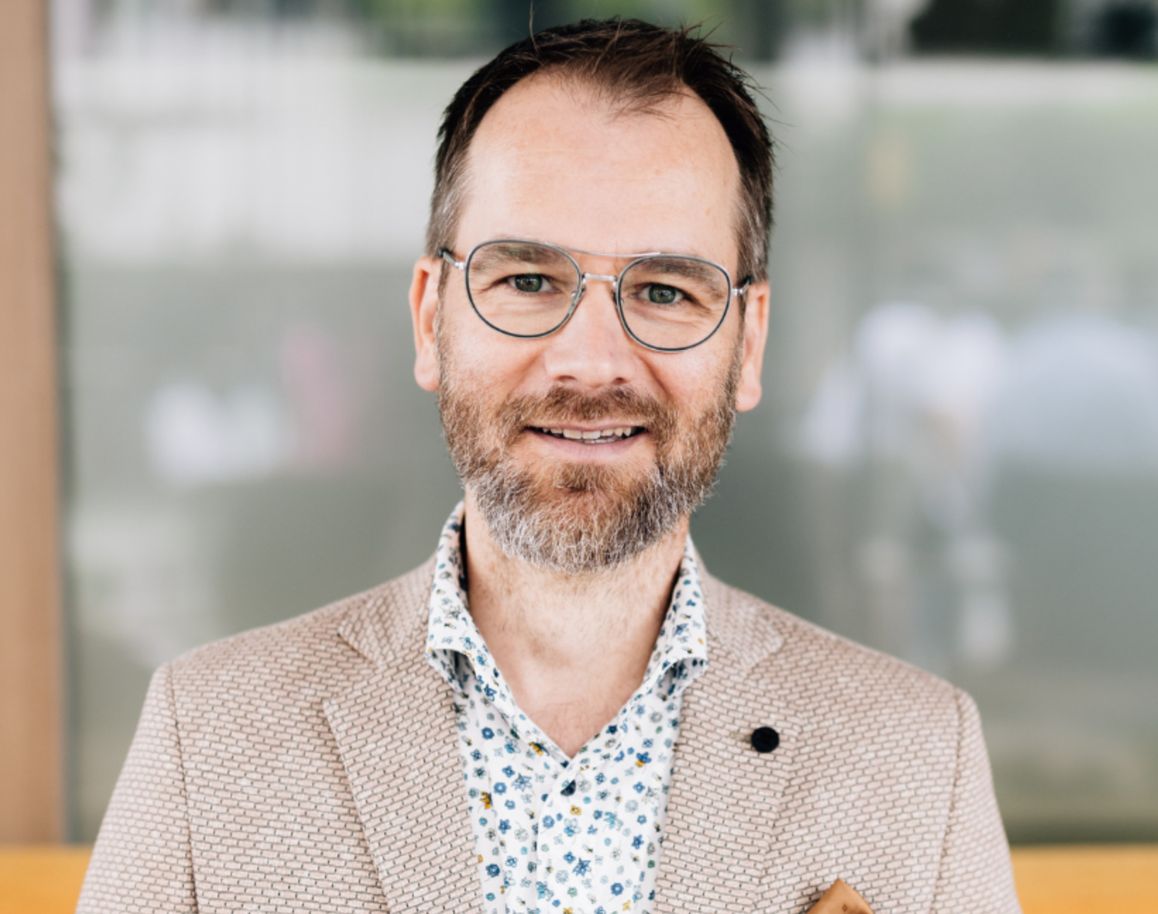 Keynote Speaker und Entwickler des Persönlichkeitstest COLORLYTIX® Karsten Homann mit hellem Sakko lächelnd.