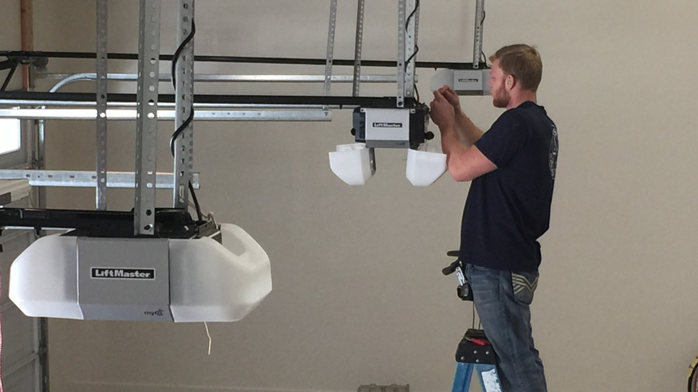 Technician repairing garage door opener
